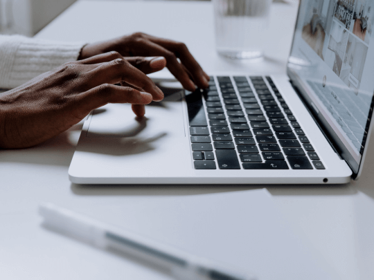 Person Using Macbook Pro on White Table while blogging for business