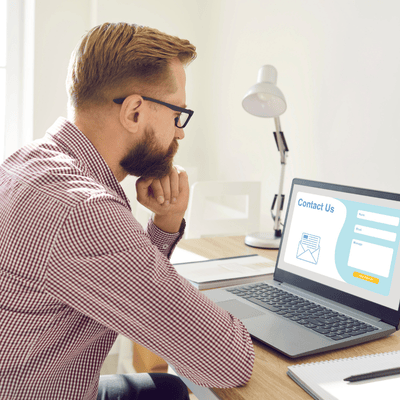 Man Sitting and Thinking What to Write in Contact Us Form on Landing Page Website