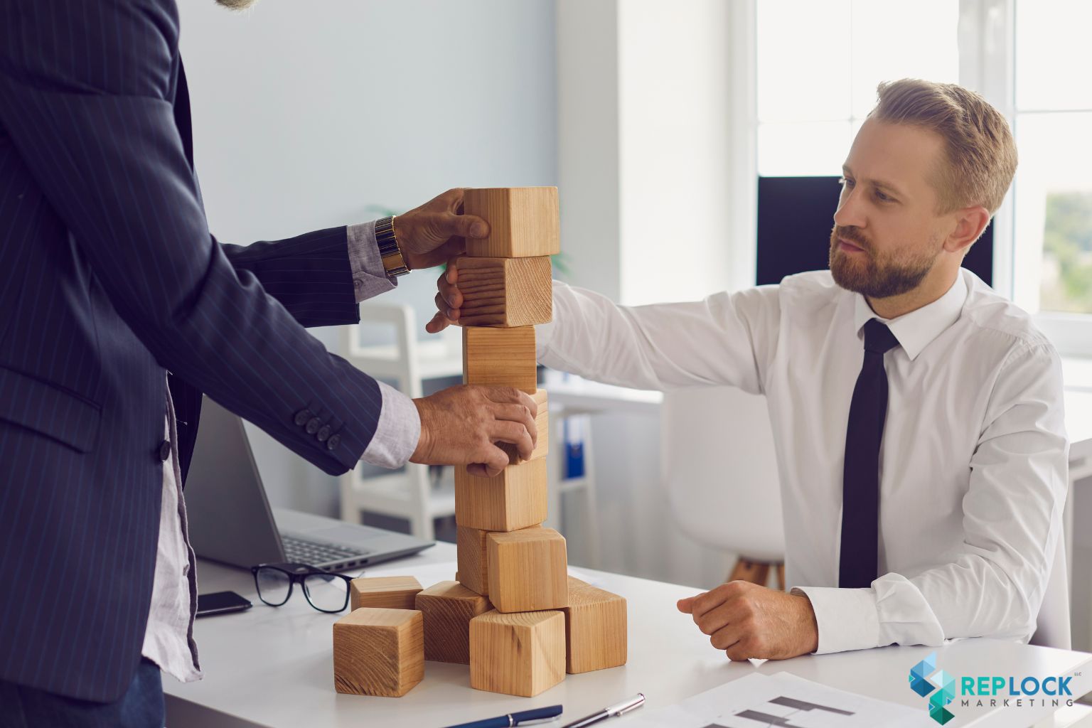 Two professionals stacking wooden blocks, symbolizing building marketing authority