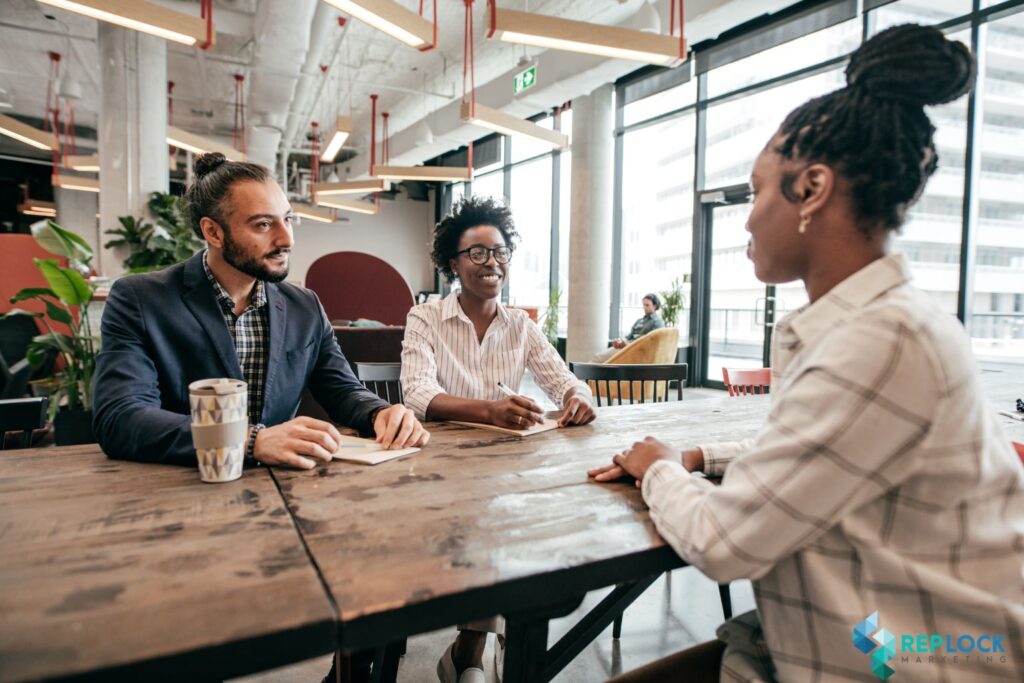 Three professionals discussing how to choose a marketing agency