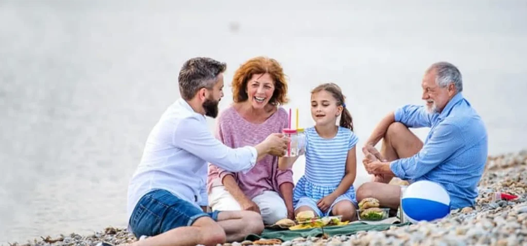 generational family enjoying time on beach