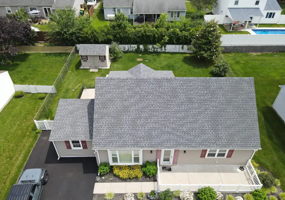 Aerial view of a house with a gray shingle roof