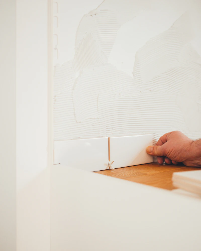 Hand fitting a new drywall panel into place