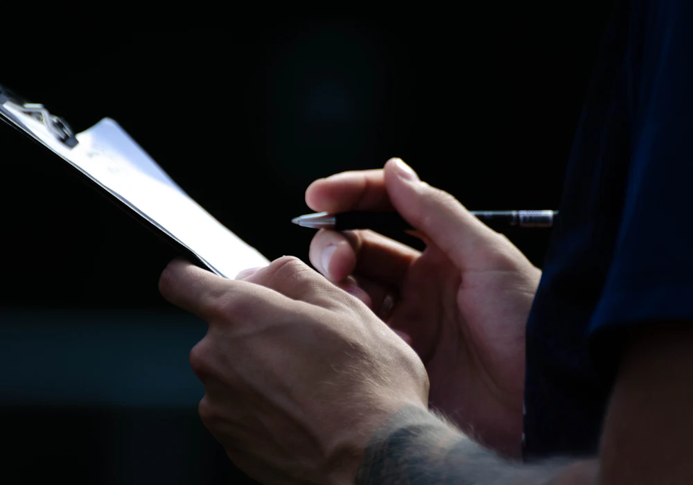 Inspector writing notes on a clipboard