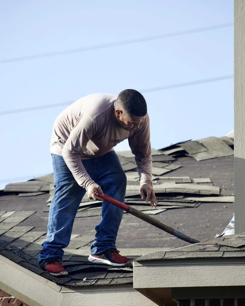 Worker repairing a section of a house roof
