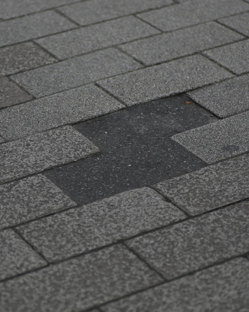 Asphalt roof with missing and damaged shingles