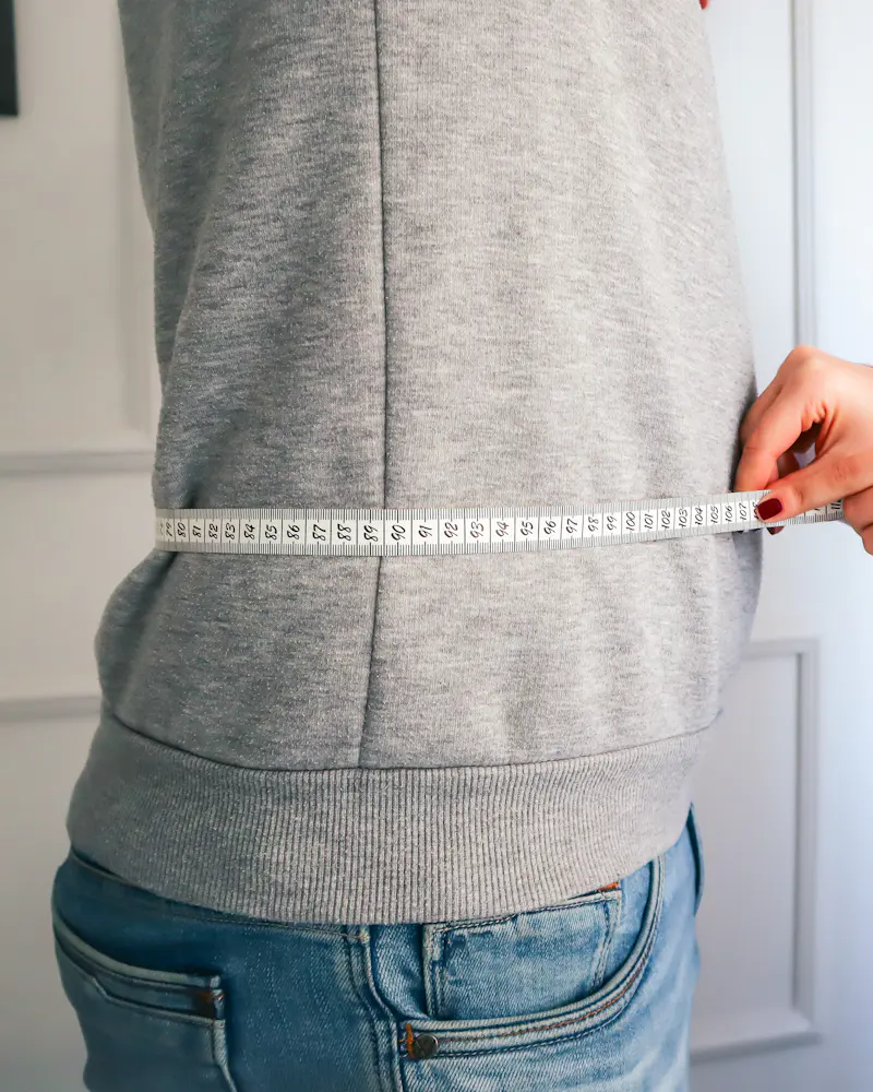 Tailor taking a waist measurement
