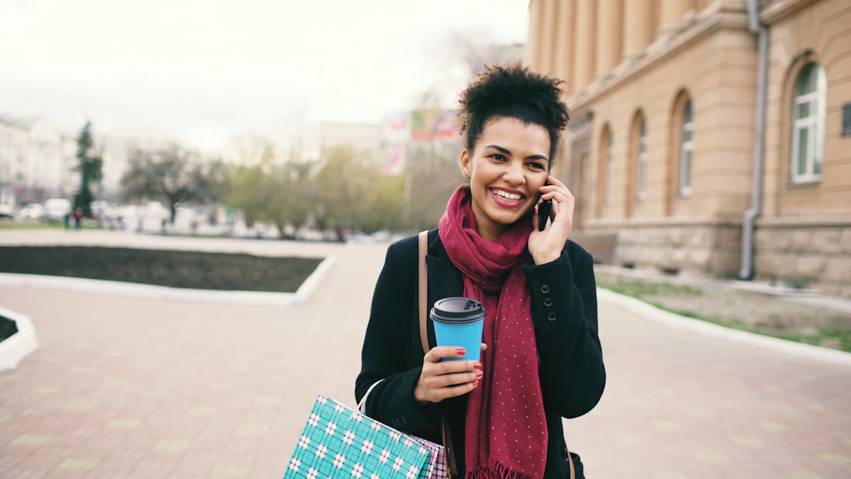 Smiling woman holding a coffee and talking on her phone while walking outside