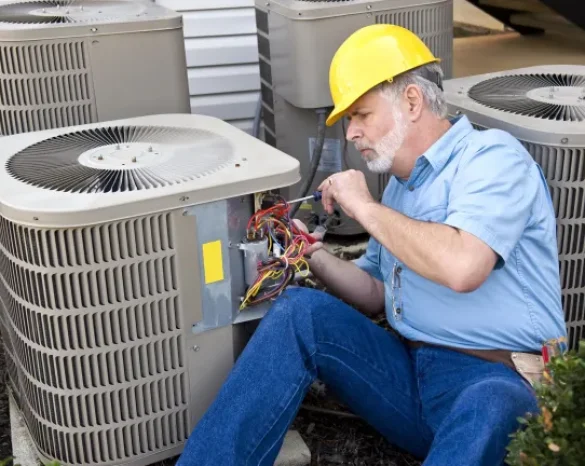 Older technician repairing ac unit
