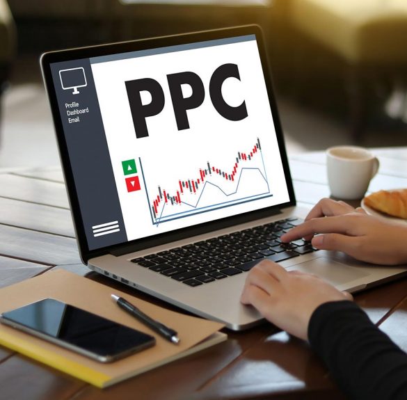 Woman on computer with ppc on screen